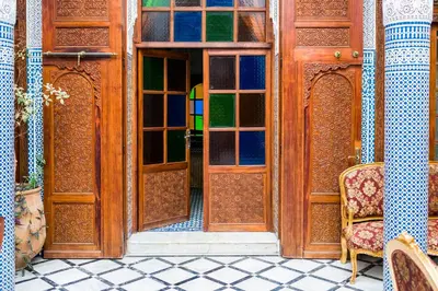 an open door with a chair in a room at Riad Tahra & Spa in Fès