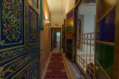 a hallway with blue and green walls and a stairway at Riad Tahra & Spa in Fès