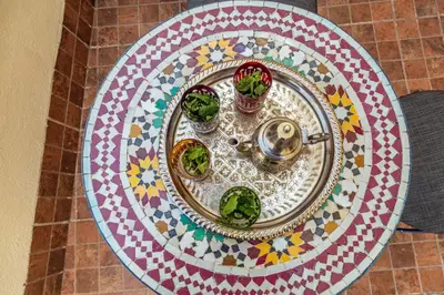 a table with a plate with plants on it at Riad Tahra & Spa in Fès