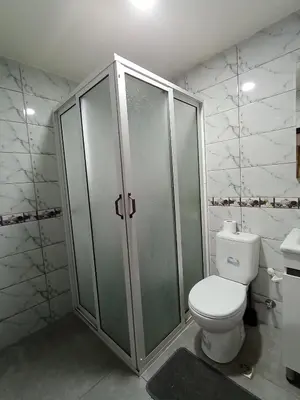a bathroom with a toilet and a shower and a sink at résidence sara in Fès