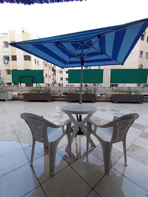 a table and chairs with an umbrella on a patio at résidence sara in Fès