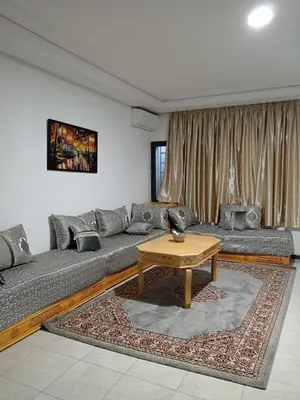 a living room with a couch and a table at résidence sara in Fès