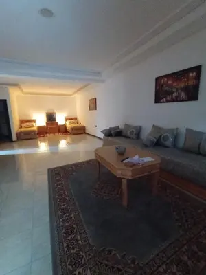 a living room with a couch and a coffee table at résidence sara in Fès