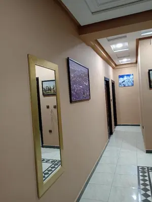 a hallway with a mirror on a wall at résidence sara in Fès