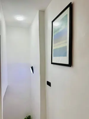 a picture hanging on a wall in a room at Maison N 20 in Oulad Akkou