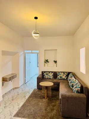a living room with a couch and a table at Maison N 20 in Oulad Akkou