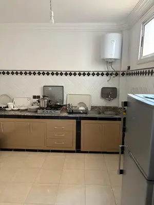 a kitchen with a counter top and a kitchen with at Résidence Oslo in Khemisset