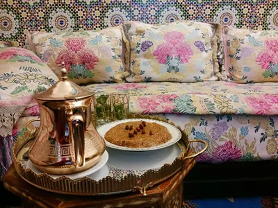 a tea kettle on a table next to a couch at el habib in Fès