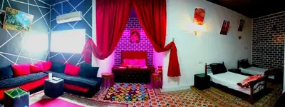 a living room with a purple and pink room at el habib in Fès