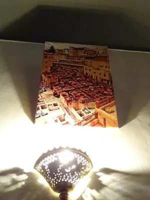 a light on top of a box with a picture at el habib in Fès
