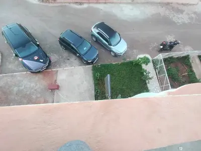 a group of three cars parked in a parking lot at Maison d'hôte Najah 2 in Khenifra