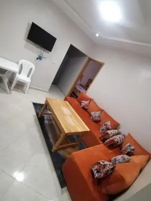 a living room with a couch and a table at Maison d'hôte Najah 2 in Khenifra