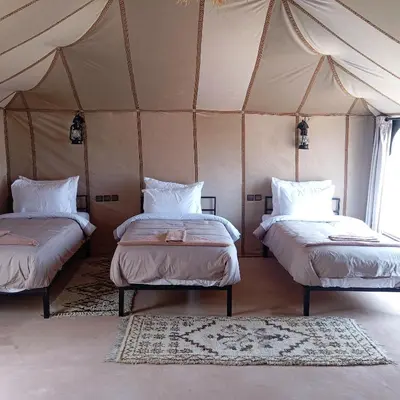 a bedroom with two beds in a tent at Serenity desert luxury Camp in Merzouga