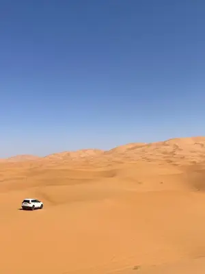 a car driving through the desert at Luxury Merzouga stars camp in Merzouga