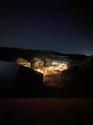 a view of a building at night with lights at Luxury Merzouga stars camp in Merzouga