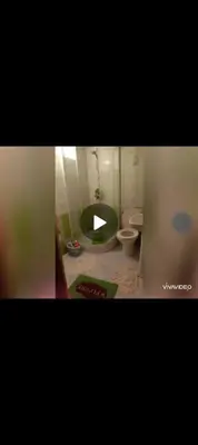 a bathroom with a toilet and a green tub at FeS in Fès