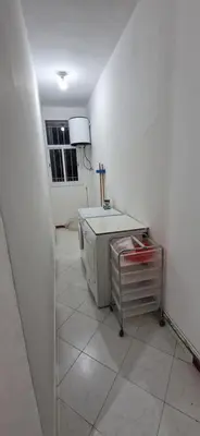 a white room with a table and a refrigerator at Appartement de charme in Fès