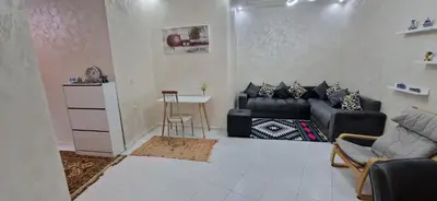 a living room with a couch and a table at Appartement de charme in Fès