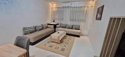 a living room with a couch and a table at Cozy apartment in Fès