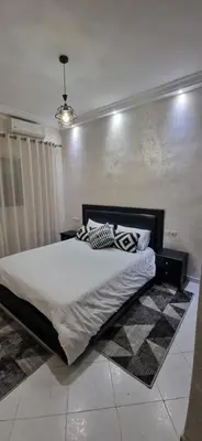 a bedroom with a large bed in a room at Cozy apartment in Fès