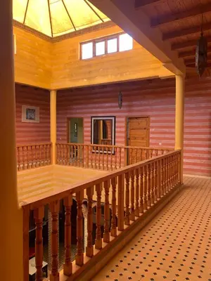 a balcony of a wooden house with a skylight at Riad Belgika Marrakech in Ourika