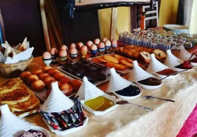 a table with eggs and other food on it at Merzouga Berber Luxury Camp in Merzouga