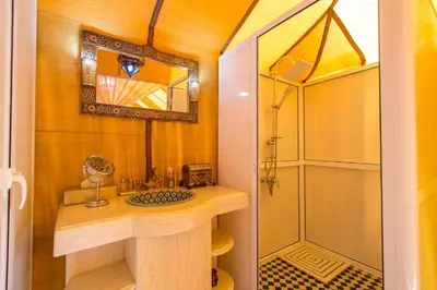 a bathroom with a sink and a shower at Merzouga Berber Luxury Camp in Merzouga