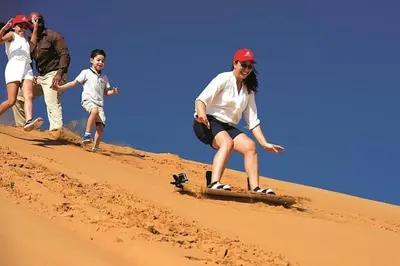 a group of people on a skateboard in the sand at Merzouga Berber Luxury Camp in Merzouga
