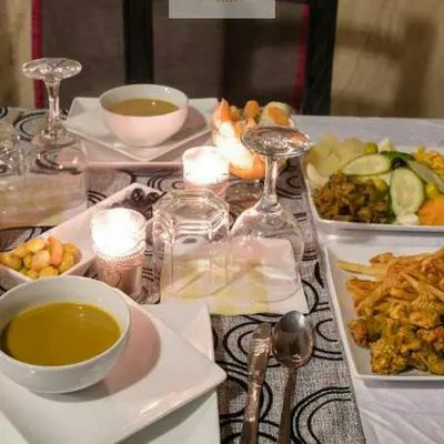 a table with plates of food and bowls of soup at Merzouga Berber Luxury Camp in Merzouga