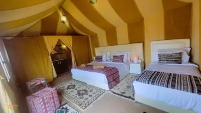 a bedroom with two beds in a room at Merzouga Berber Luxury Camp in Merzouga