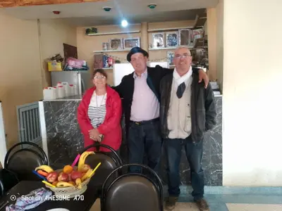 a group of three people posing for a picture at Ait hani in Tinerhir