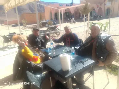 a group of people sitting at a table at Ait hani in Tinerhir