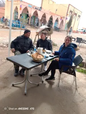 a group of people sitting at a table at Ait hani in Tinerhir