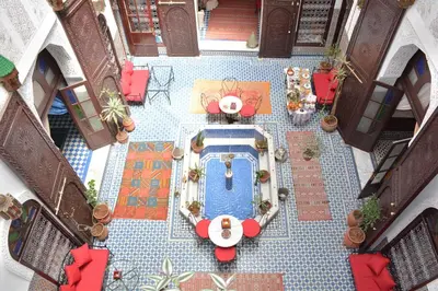 an overhead view of a patio with a table and chairs at Dar Al Batoul in Fès