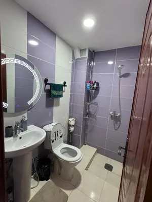 a bathroom with a toilet and a sink and a shower at Home Louah Apartment Retreat in Oulad Tayeb