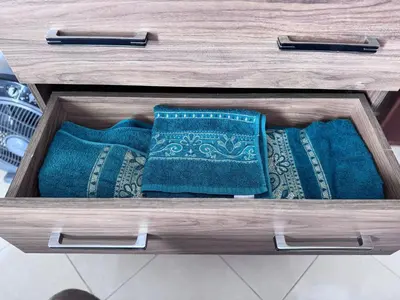 a wooden drawer with blue pillows in a wooden table at Home Louah Apartment Retreat in Oulad Tayeb