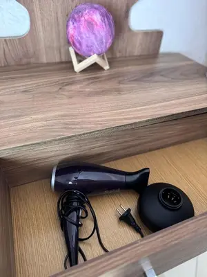 a black hair dryer sitting on top of a drawer at Home Louah Apartment Retreat in Oulad Tayeb