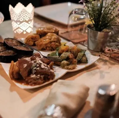 a table with two plates of food on it at Merzouga Queen Luxury Camp in Merzouga