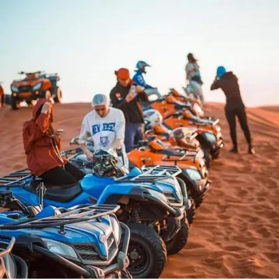 a group of motorcycles parked in the desert at Merzouga Queen Luxury Camp in Merzouga