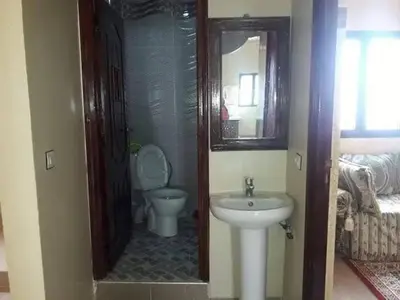 a bathroom with a toilet and a sink at Merzouga camp activités in Merzouga