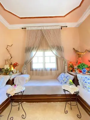 a bedroom with two beds and a window at The Big Moon in Skoura