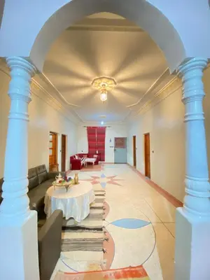 a large living room with a table and a couch at The Big Moon in Skoura