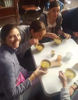 a group of people sitting at a table eating food at Fès Dar medina in Fès
