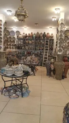 a store filled with lots of plates and vases at Fès Dar medina in Fès