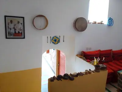 a living room with a couch and a table with shoes at Ait Sedrate Tourism Cooperative Hotel in Boumalne