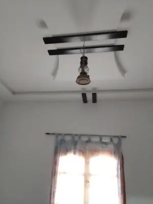 a ceiling fan in a room with a window at Ait Sedrate Tourism Cooperative Hotel in Boumalne