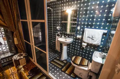 a small bathroom with a sink and a toilet at Riad Famille Drissi Kaitouni in Fès
