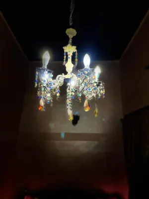a chandelier hanging from the ceiling in a room at Riad Famille Drissi Kaitouni in Fès