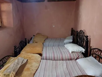 two twin beds in a room at gite Imouzar in Iabassene