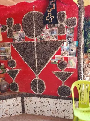 a red wall with a picture of martini glasses at gite Imouzar in Iabassene